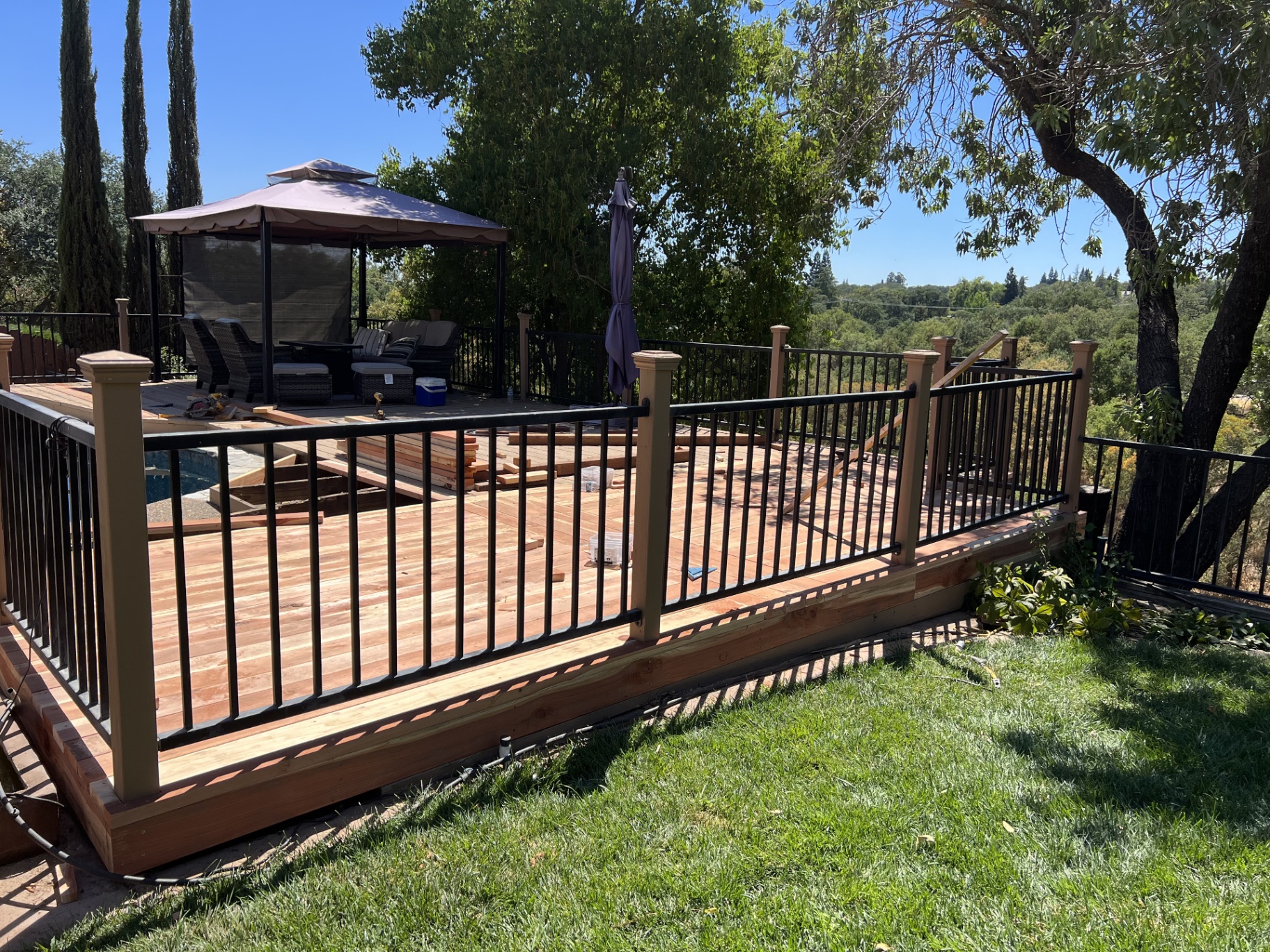 Redwood pool deck with iron railing — Roseville